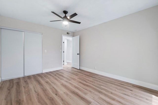 unfurnished bedroom with a closet, ceiling fan, and light hardwood / wood-style flooring