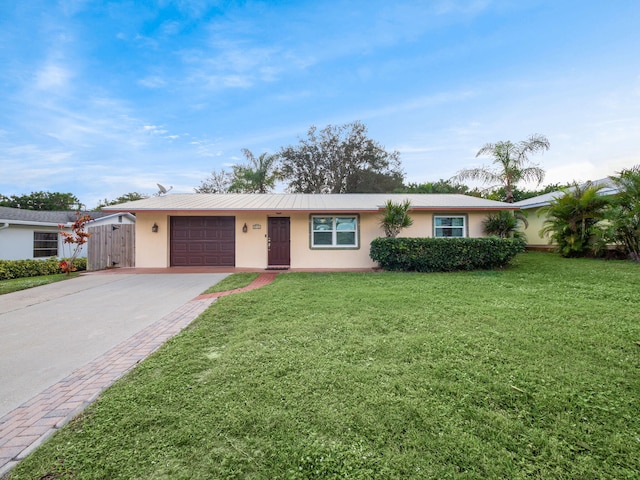 ranch-style home featuring a front yard and a garage