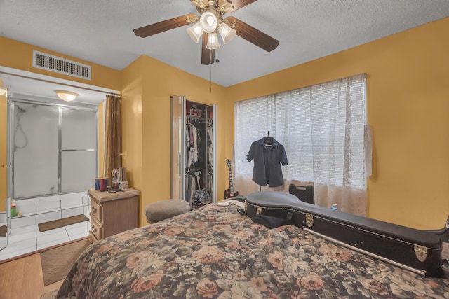 bedroom featuring a textured ceiling and ceiling fan