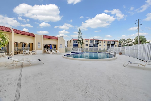 view of swimming pool featuring a patio area