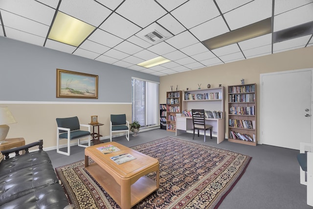 living room featuring a paneled ceiling