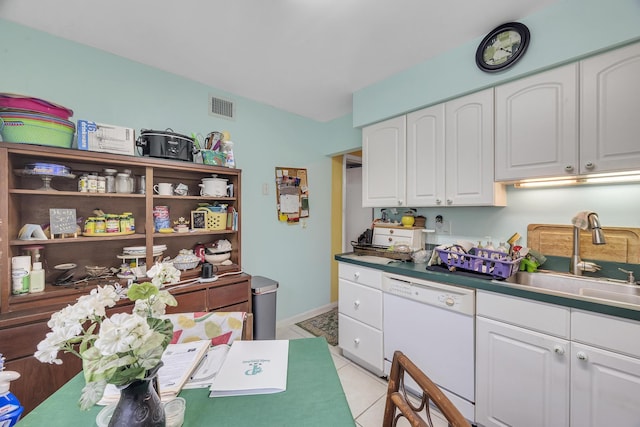 kitchen featuring white cabinetry, white dishwasher, sink, and light tile patterned floors