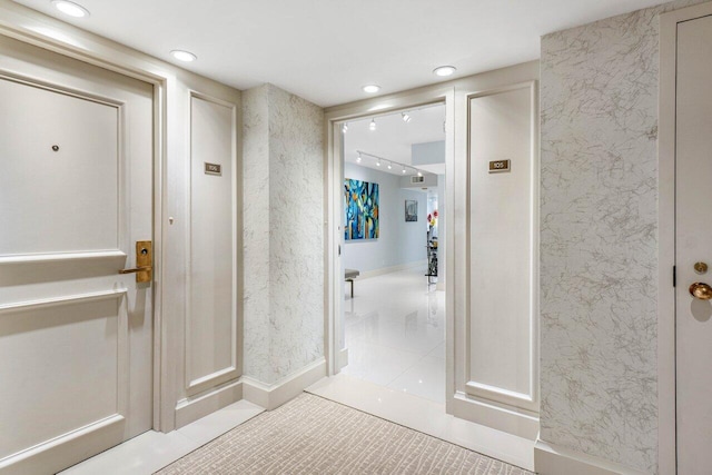 corridor featuring light tile patterned floors