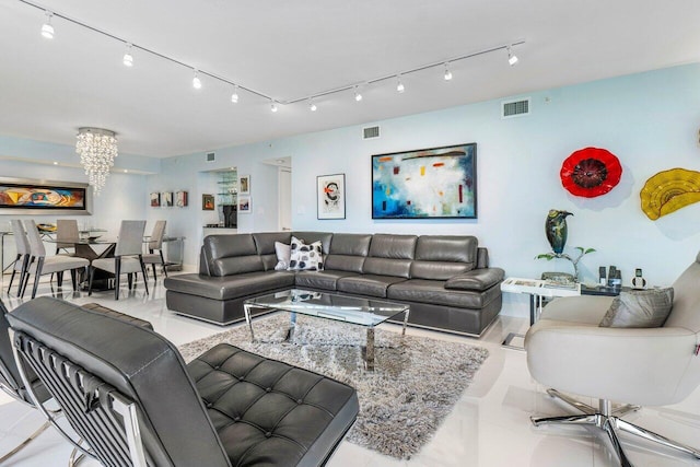 tiled living room with an inviting chandelier