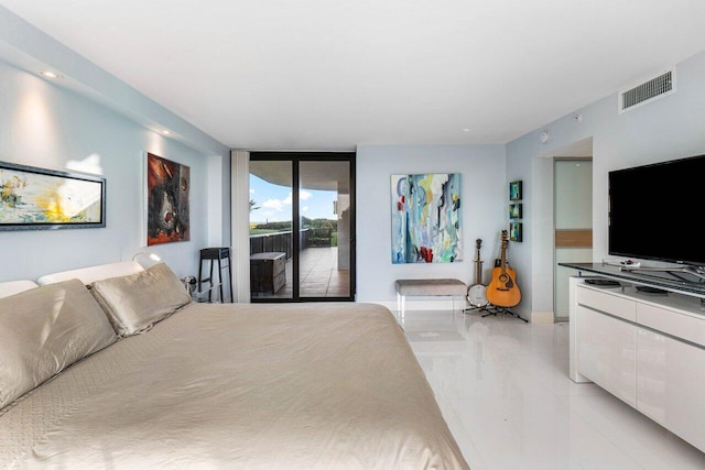 tiled bedroom with a wall of windows and access to outside