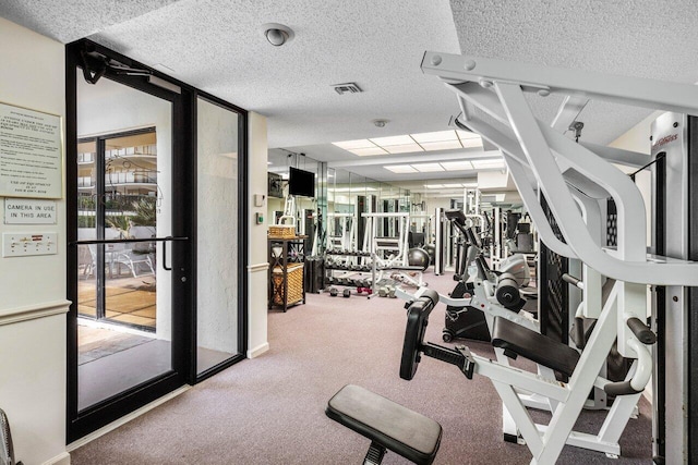 exercise room featuring a textured ceiling