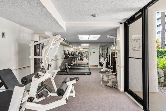 exercise room with a textured ceiling