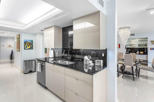 kitchen featuring stainless steel dishwasher, dark stone counters, sink, a raised ceiling, and light tile patterned floors