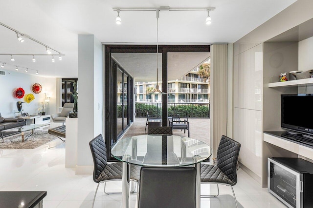 tiled dining space with a wall of windows