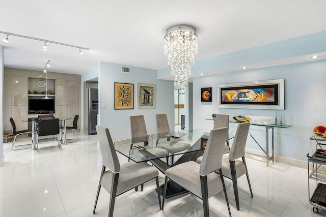 tiled dining space featuring an inviting chandelier