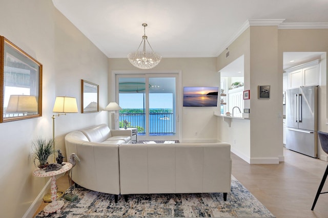 living room featuring crown molding and an inviting chandelier