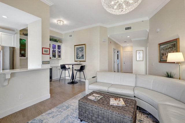 living room with ornamental molding, light hardwood / wood-style flooring, and an inviting chandelier