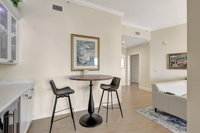 dining space featuring crown molding