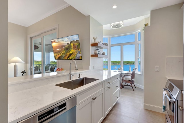 kitchen with dishwasher, white cabinets, sink, wall oven, and light stone counters