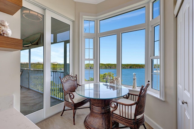 sunroom / solarium featuring a water view