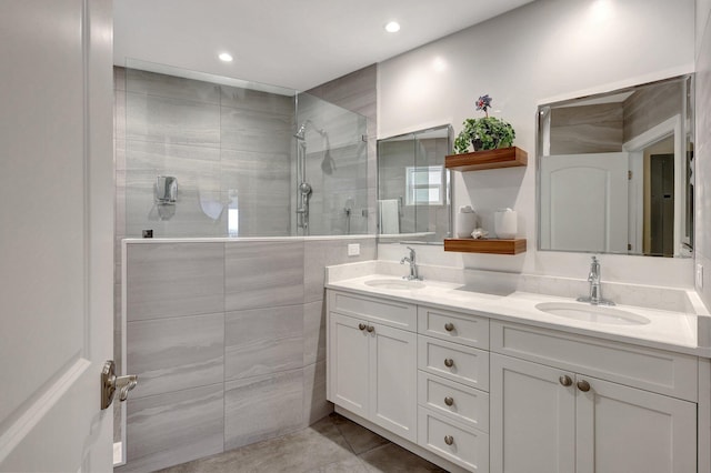 bathroom with tile patterned flooring, vanity, and a shower with shower door