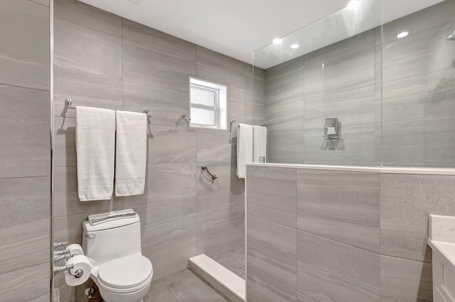 bathroom featuring vanity, toilet, and tiled shower