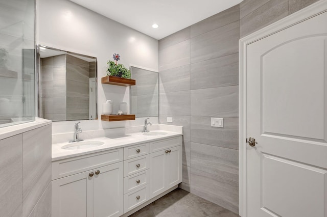 bathroom featuring vanity and tile walls