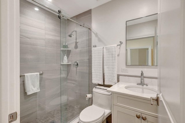 bathroom featuring an enclosed shower, vanity, and toilet