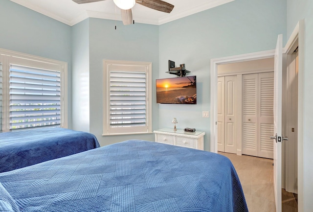 bedroom featuring a closet, ceiling fan, and ornamental molding