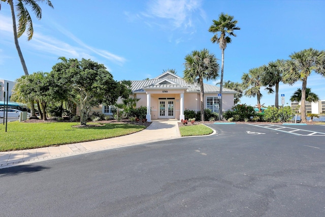 view of front of house featuring a front yard and french doors