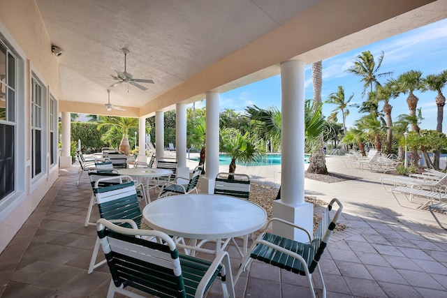 view of patio / terrace with ceiling fan and a community pool