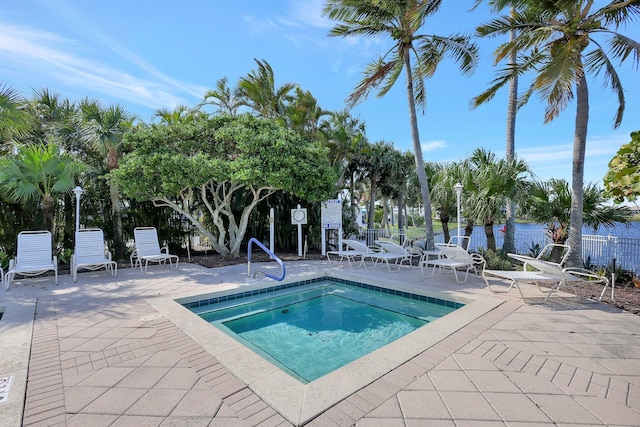 view of swimming pool with a community hot tub, a patio, and a water view