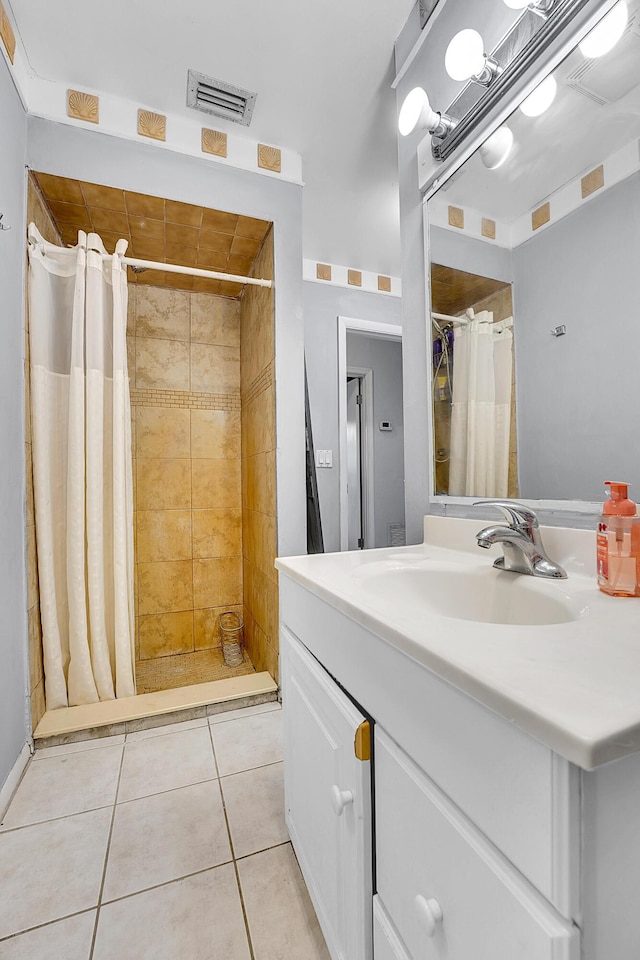 bathroom featuring a shower with curtain, vanity, and tile patterned floors