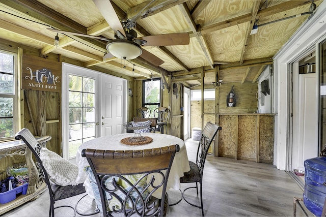 sunroom featuring beam ceiling, plenty of natural light, and ceiling fan