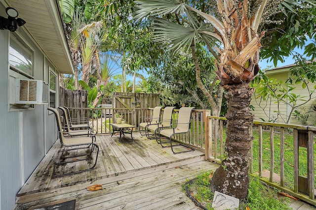 wooden deck featuring cooling unit