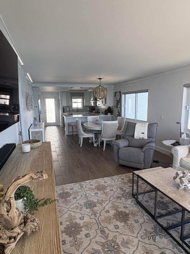 living room with hardwood / wood-style floors and crown molding