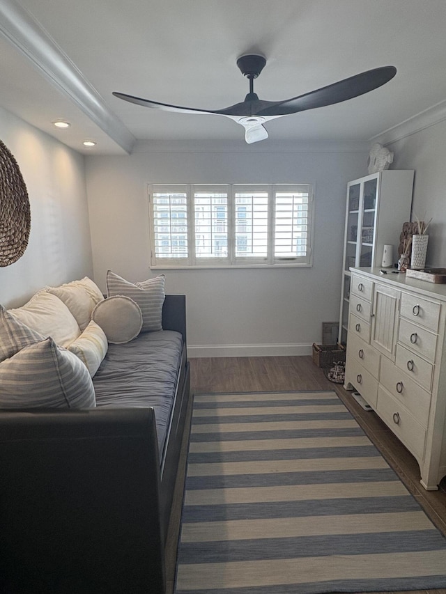 sitting room featuring ceiling fan, a healthy amount of sunlight, dark hardwood / wood-style flooring, and ornamental molding