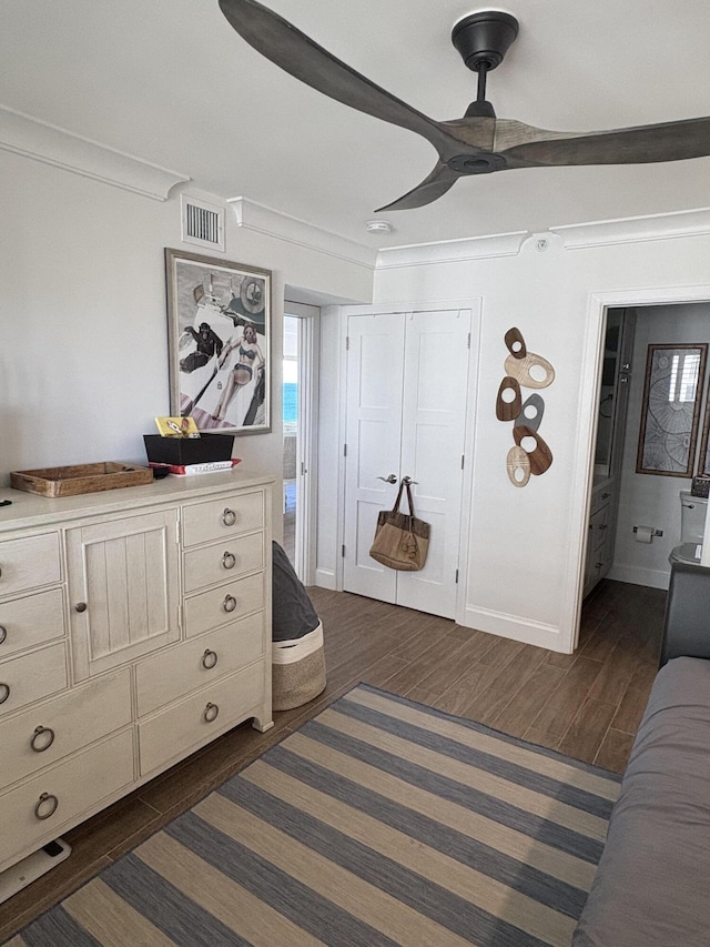 bedroom with ceiling fan and ornamental molding