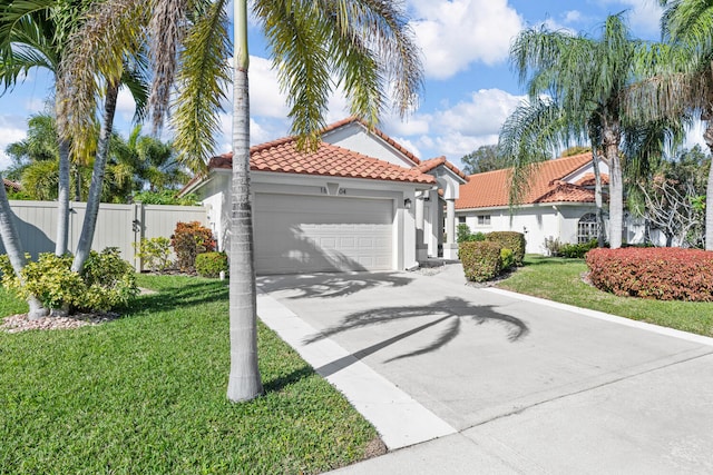 mediterranean / spanish house with a front yard and a garage