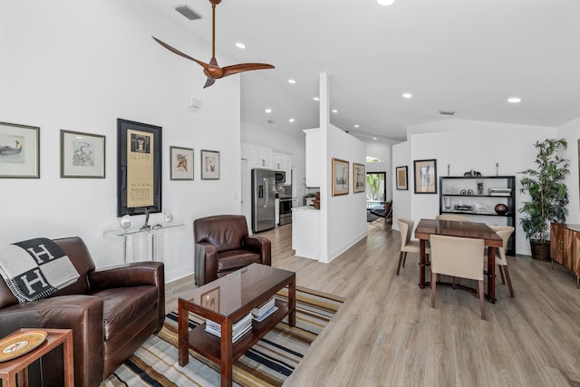 living room with ceiling fan and light hardwood / wood-style flooring