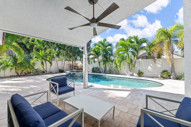 view of swimming pool with ceiling fan, a patio area, an outdoor living space, and an in ground hot tub