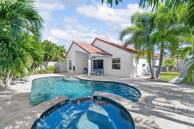 view of pool featuring a patio area, an in ground hot tub, and ceiling fan