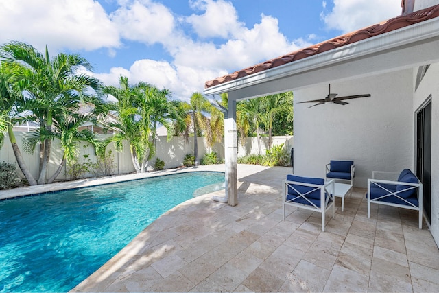 view of pool with ceiling fan and a patio