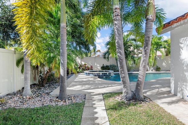 view of swimming pool featuring an in ground hot tub