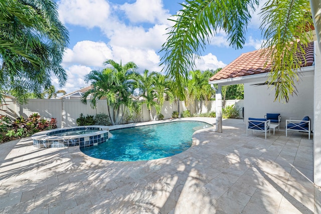 view of swimming pool featuring an in ground hot tub and a patio