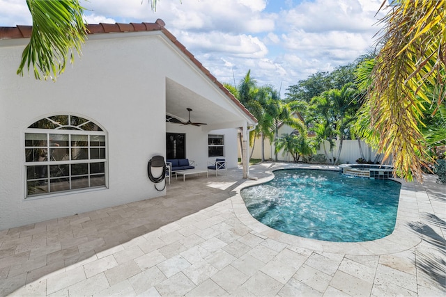 view of pool with ceiling fan, a patio area, and an in ground hot tub