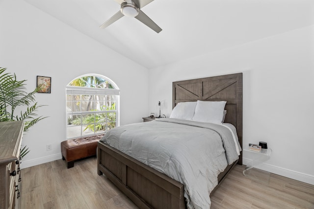 bedroom with light wood-type flooring, ceiling fan, and lofted ceiling