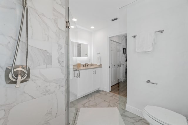 bathroom featuring vanity, toilet, and an enclosed shower