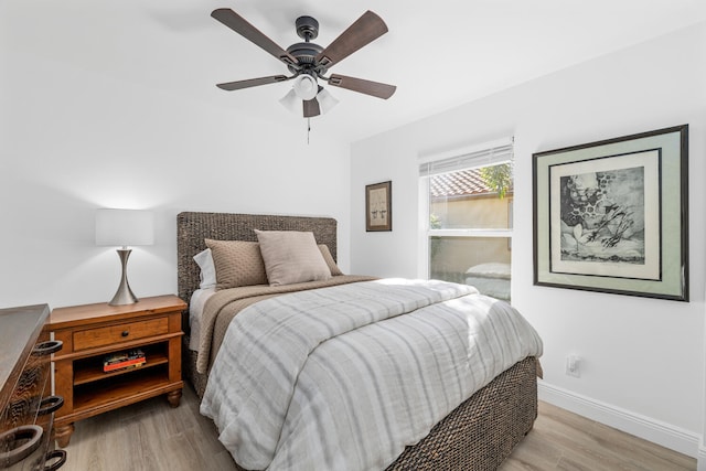 bedroom with ceiling fan and light wood-type flooring