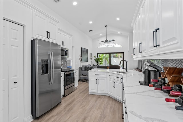 kitchen with white cabinets, sink, ceiling fan, light stone counters, and stainless steel appliances