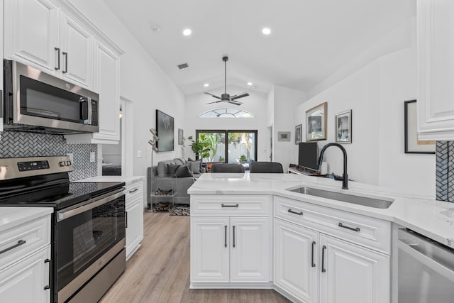 kitchen featuring decorative backsplash, sink, white cabinets, and stainless steel appliances