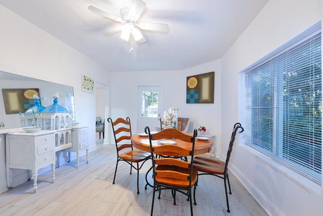 dining space with ceiling fan and light hardwood / wood-style floors