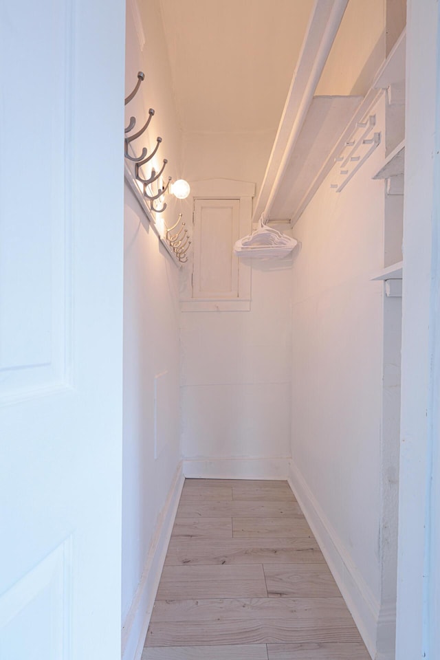 spacious closet with light hardwood / wood-style flooring