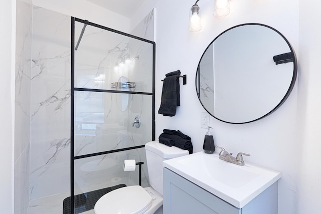 bathroom with vanity, toilet, and a shower with door