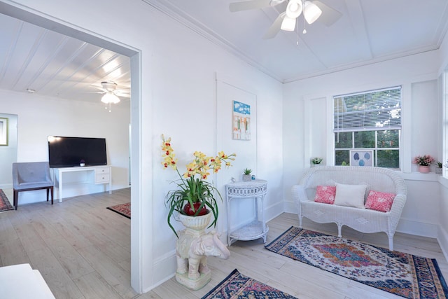 sitting room featuring crown molding and light wood-type flooring